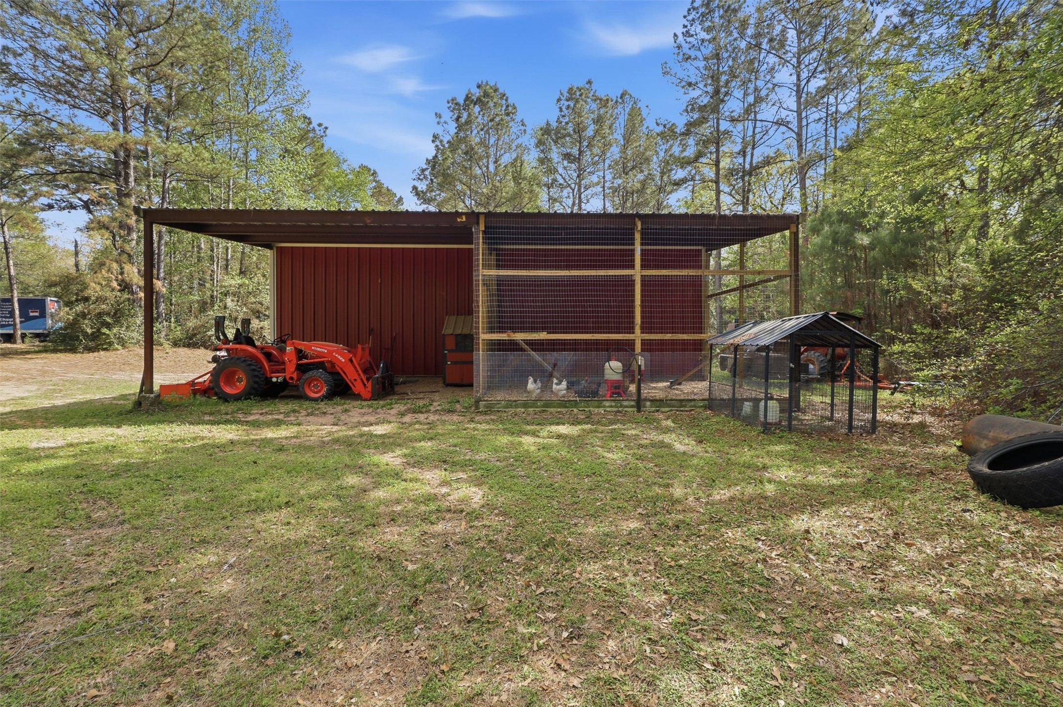 8582 Highway 75 Huntsville, TX 77340 - Photo 42 of 50 a view of a backyard with table and chairs and a fire pit