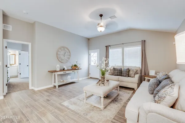 a living room with furniture and flowers