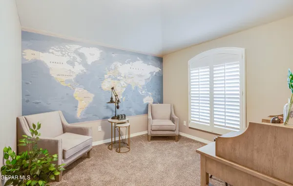 a bedroom with a bed and painting on the wall