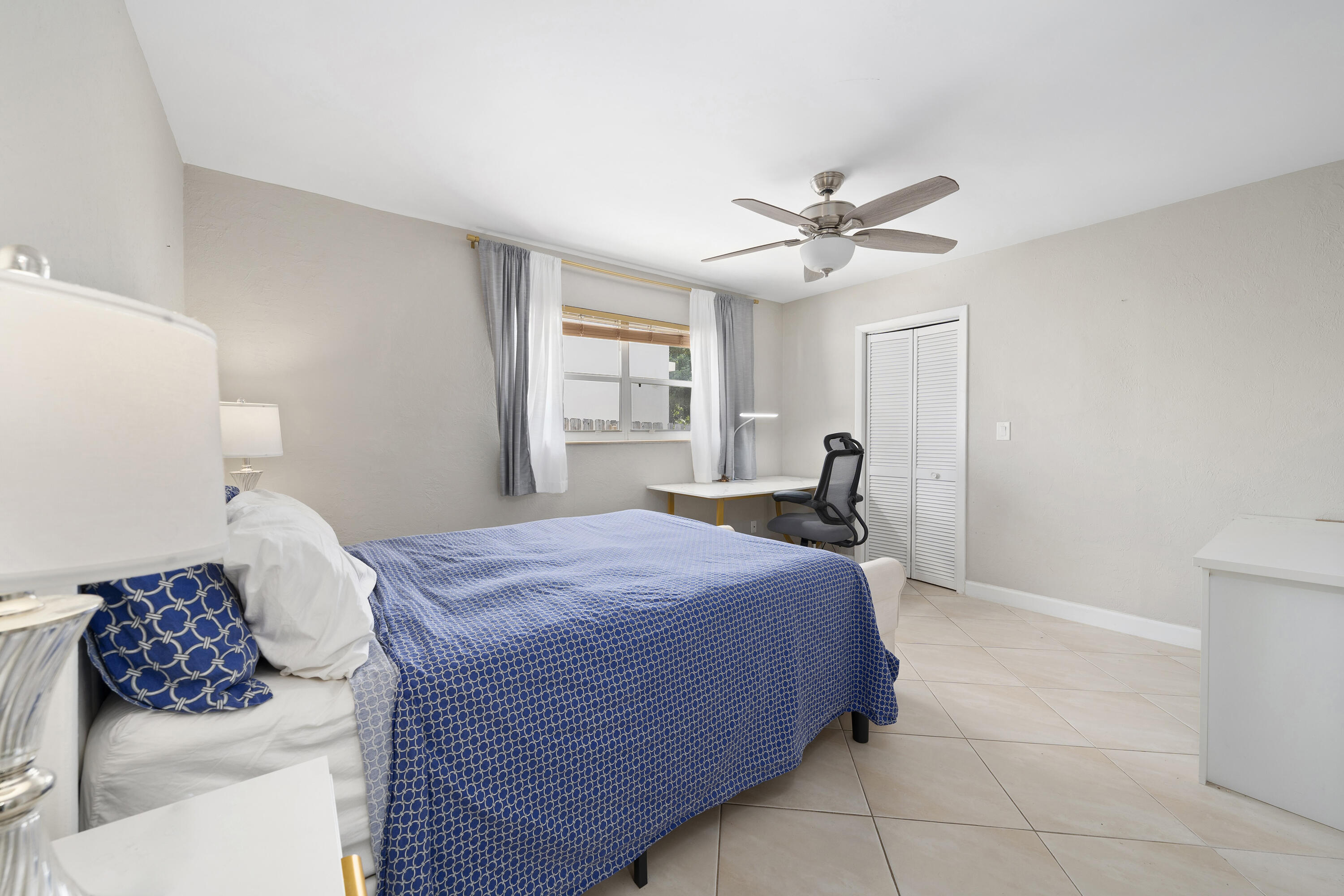 250 Northwest 11th Street Boca Raton, FL 33432 - Photo 11 of 30 a bedroom with a bed and a cabinets