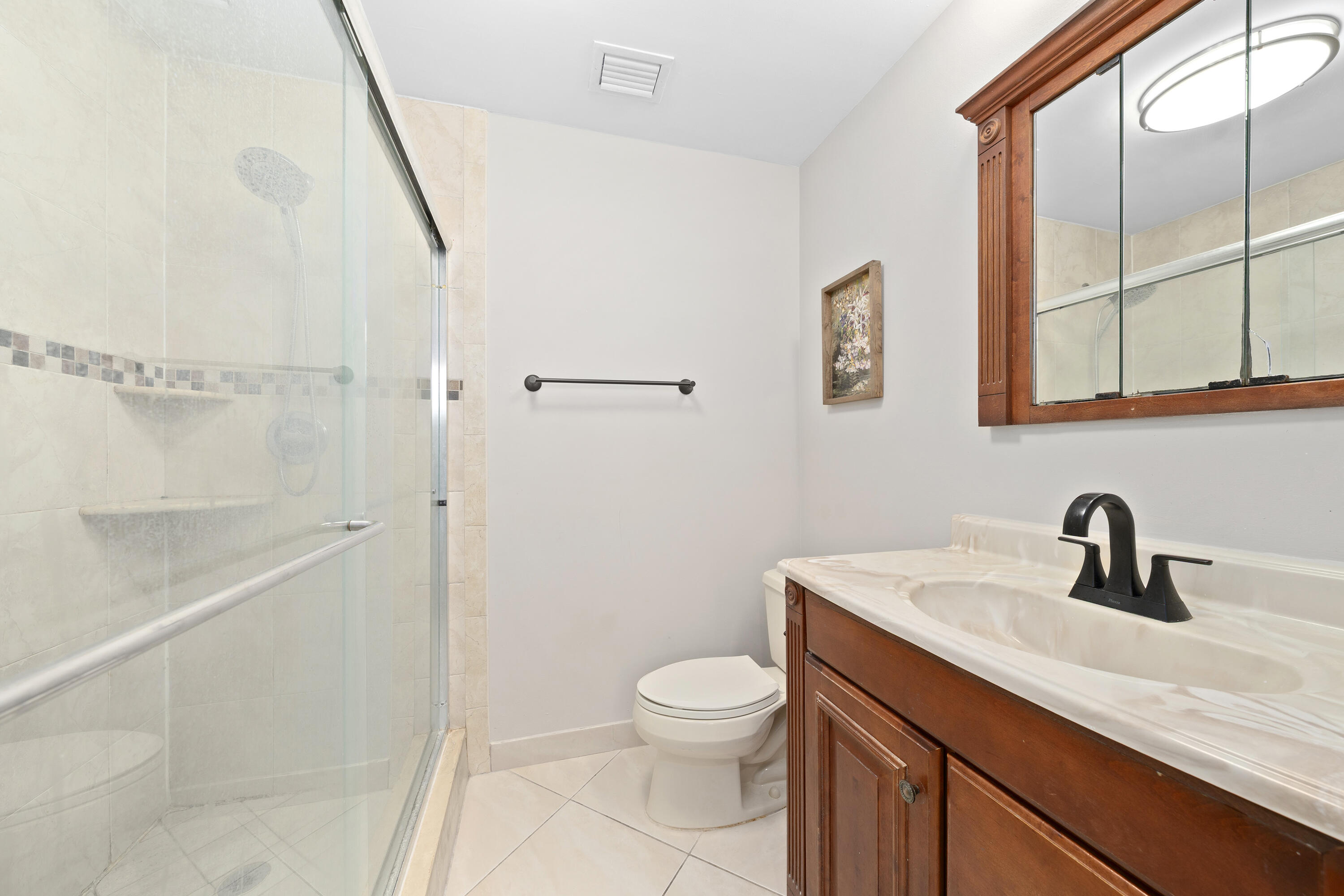 250 Northwest 11th Street Boca Raton, FL 33432 - Photo 12 of 30 a bathroom with a toilet a sink and a mirror
