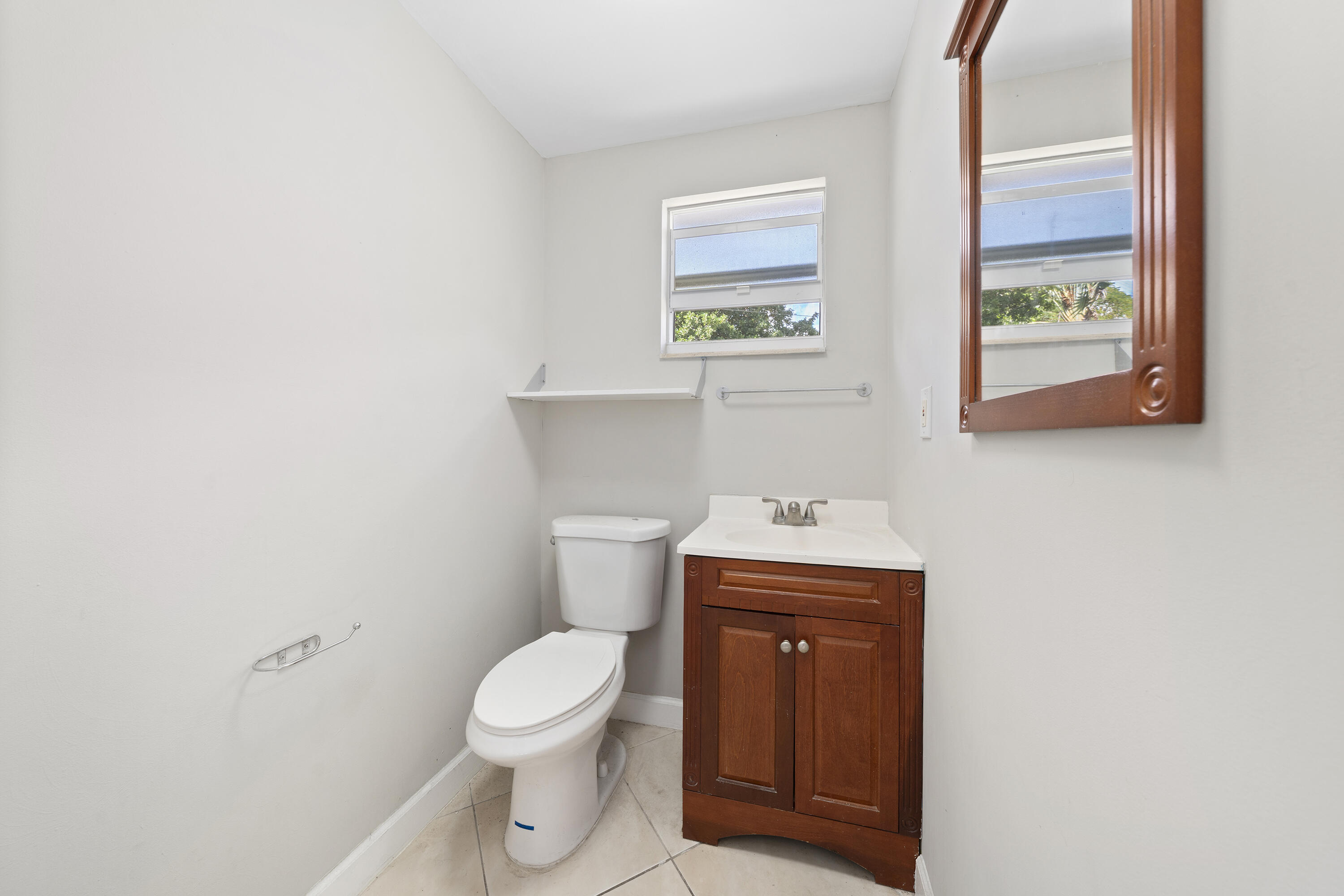 250 Northwest 11th Street Boca Raton, FL 33432 - Photo 14 of 30 a white toilet sitting next to a bathroom sink