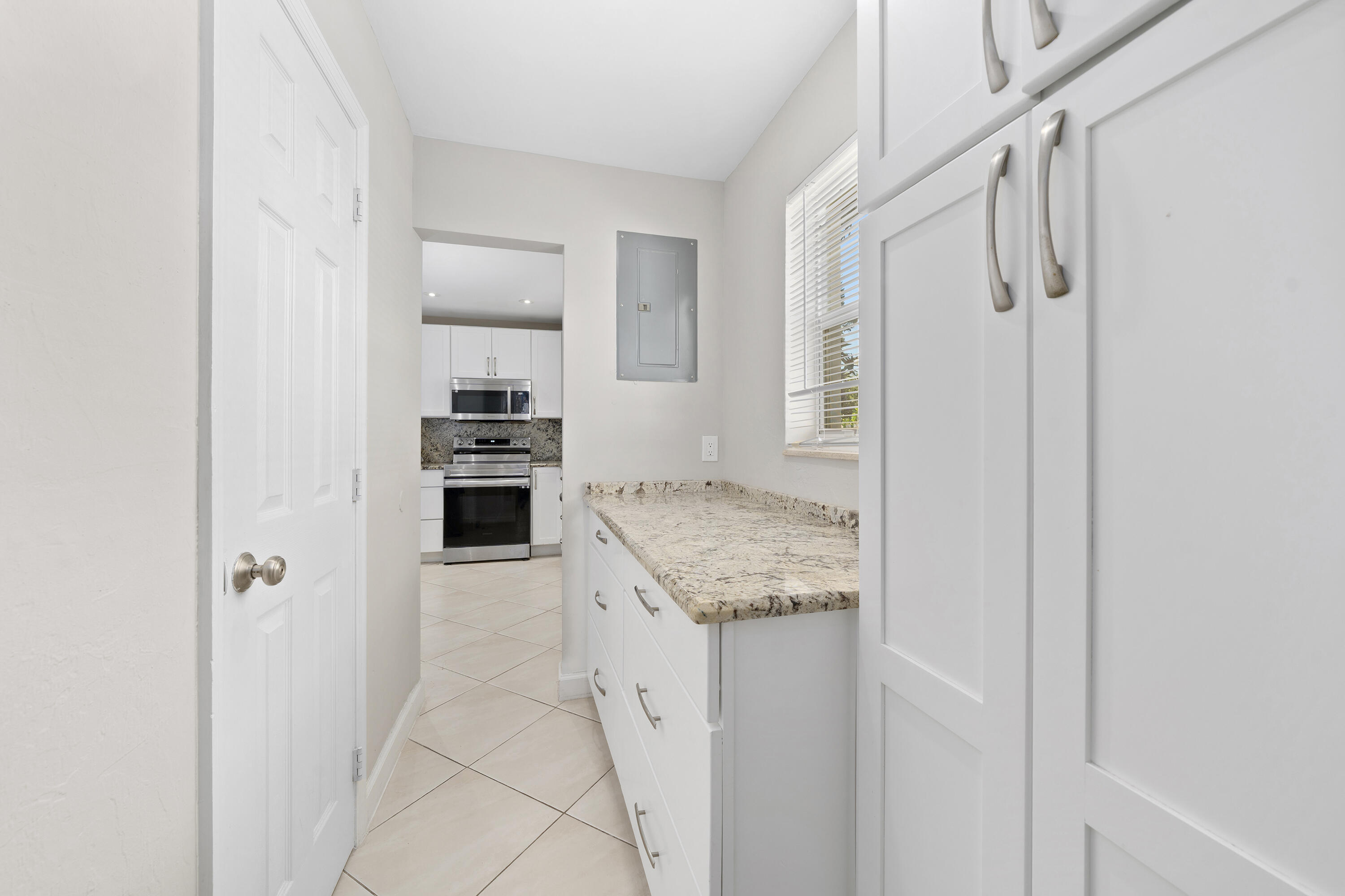 250 Northwest 11th Street Boca Raton, FL 33432 - Photo 15 of 30 a kitchen with a stove a refrigerator and a sink