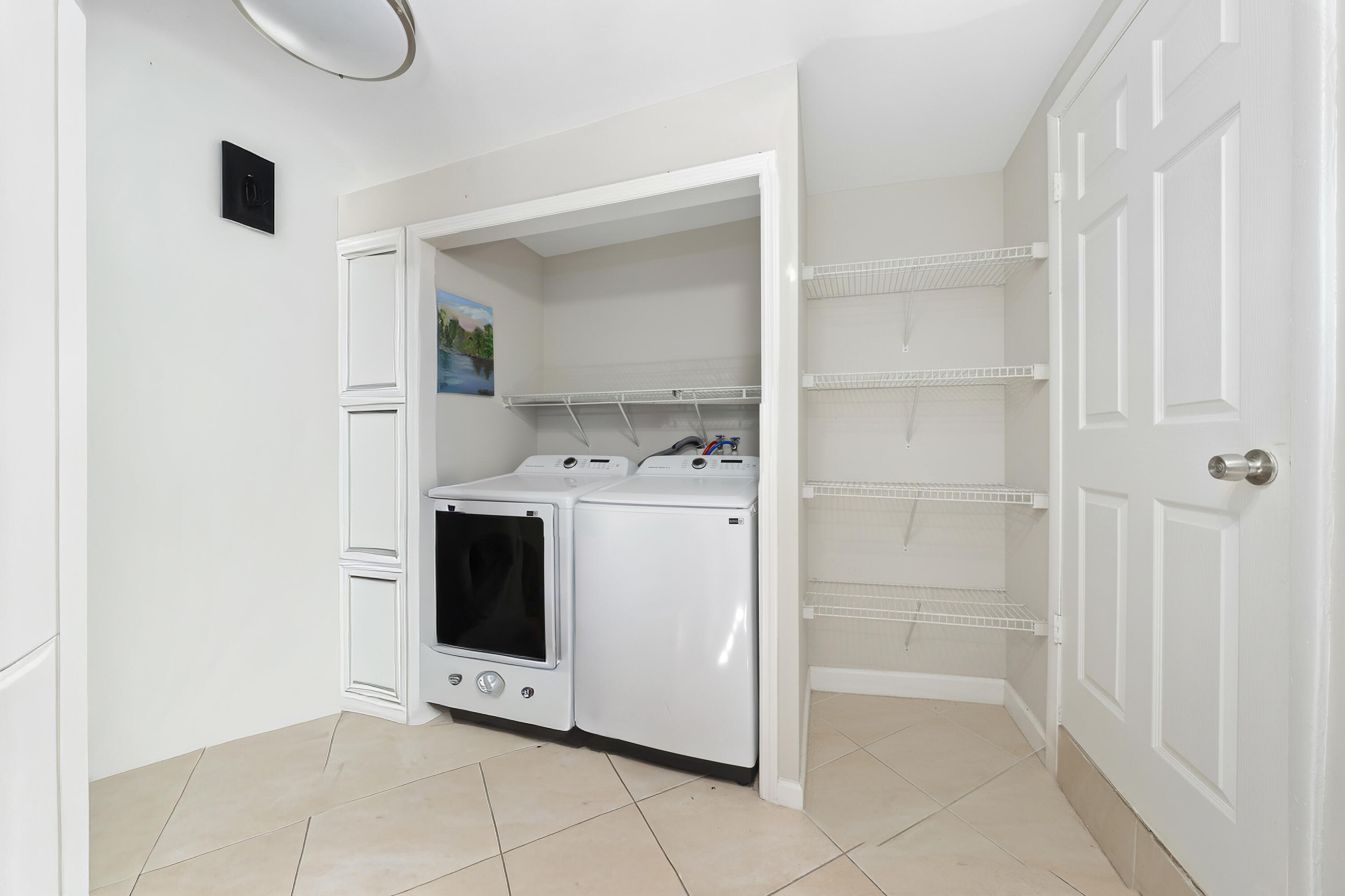 250 Northwest 11th Street Boca Raton, FL 33432 - Photo 16 of 30 a utility room with cabinets washer and dryer