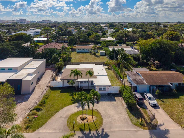 a view of a patio with table and chairs with wooden fence and plants