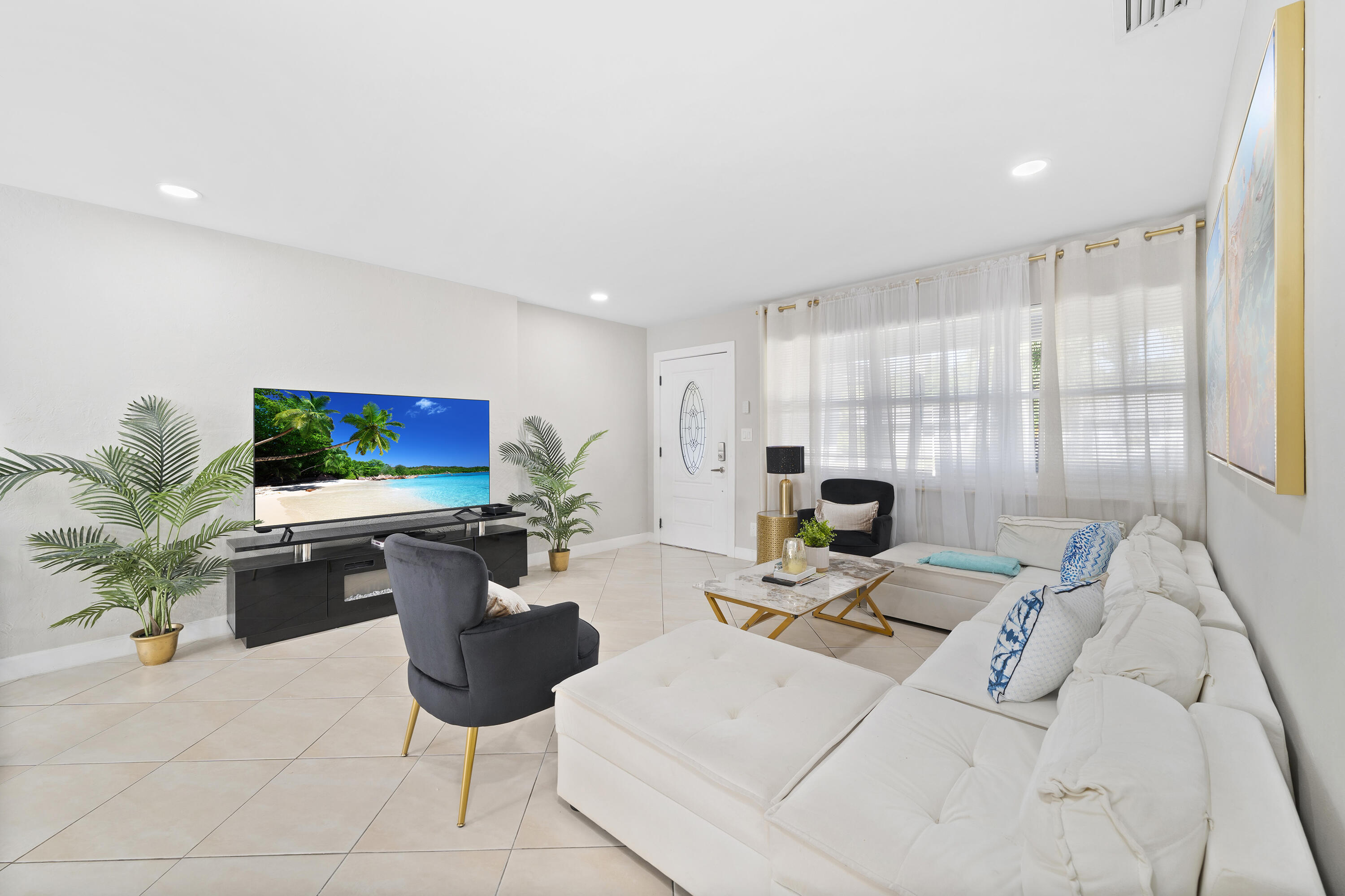 250 Northwest 11th Street Boca Raton, FL 33432 - Photo 3 of 30 a living room with furniture a flat screen tv and a large window