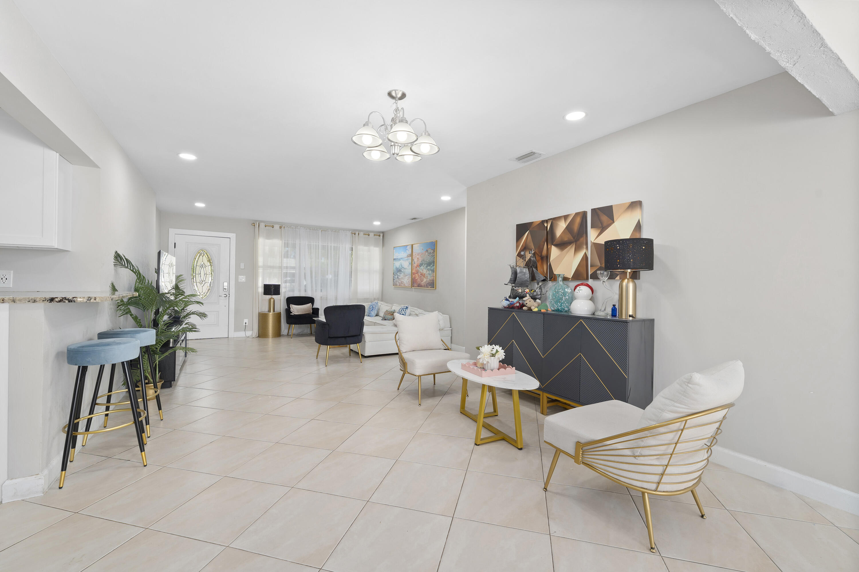 250 Northwest 11th Street Boca Raton, FL 33432 - Photo 4 of 30 a living room with furniture a dining table and a potted plant
