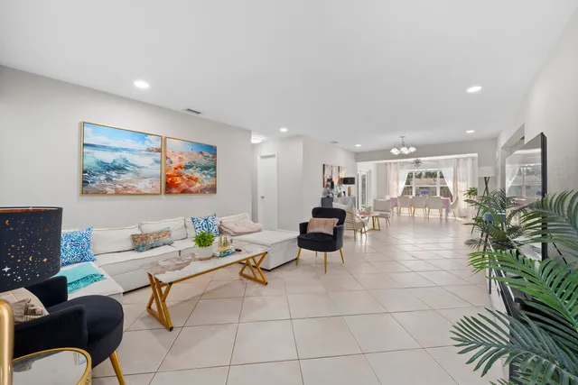 a living room with furniture and a painting on the wall