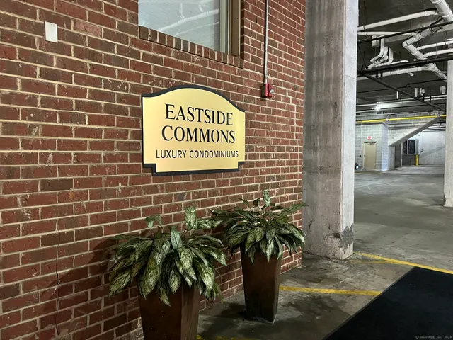 a sign that is on a brick wall