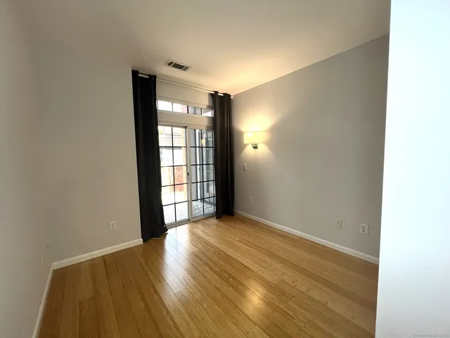 a view of wooden floor and windows in a room