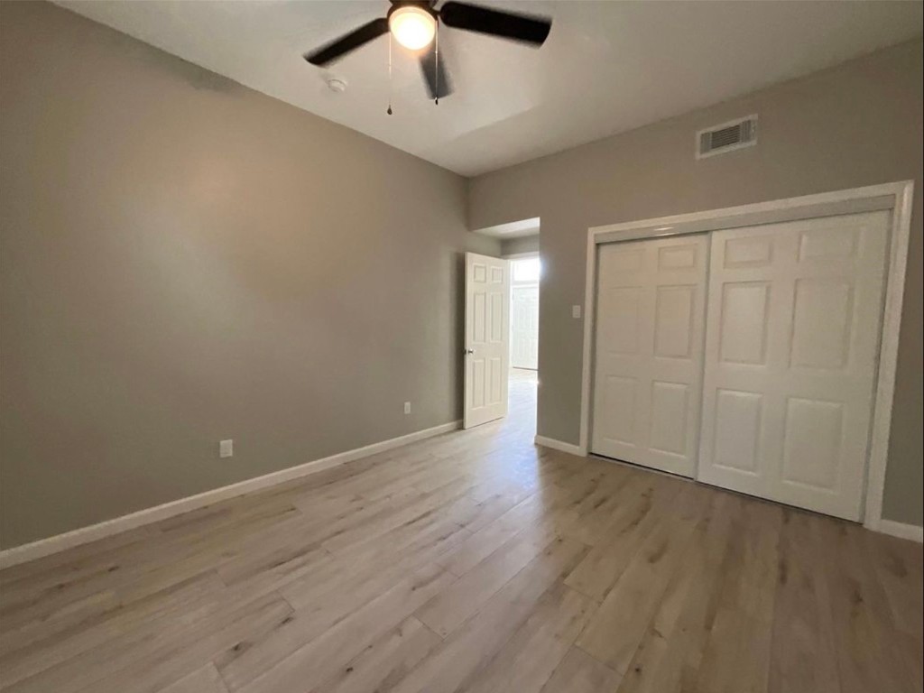 3403 Yupon Street Houston, TX 77006 - Photo 14 of 29 an empty room with wooden floor and windows