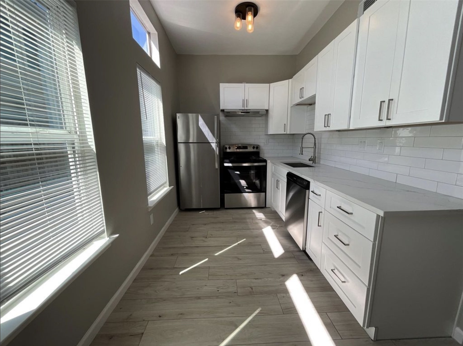 3403 Yupon Street Houston, TX 77006 - Photo 5 of 29 a kitchen with stainless steel appliances granite countertop a refrigerator and white cabinets