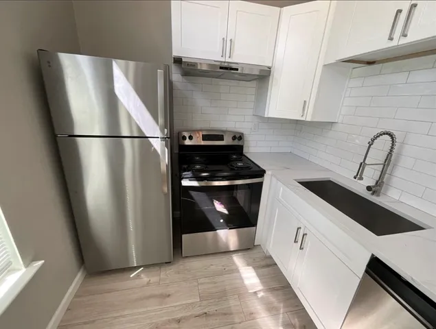 a kitchen with a refrigerator and a sink