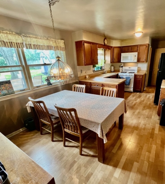 1243 Hillview Road Homewood, IL 60430 - Photo 8 of 23 a dining room with a table chairs and kitchen view