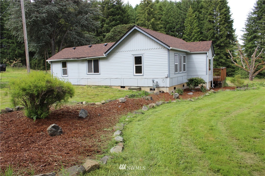 1059 Coal Creek Road Chehalis, WA 98532 - Photo 22 of 36 a view of a yard in front of a house with large trees