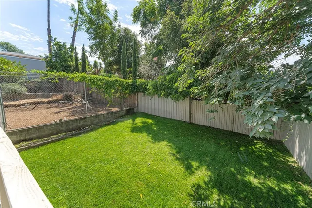 a view of a backyard with large trees
