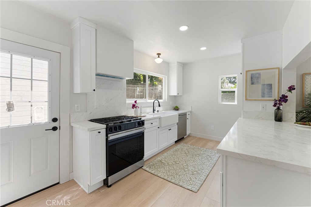 2628 Crestmoore Place Los Angeles, CA 90065 - Photo 6 of 14 a kitchen with stainless steel appliances granite countertop a stove a sink and a refrigerator