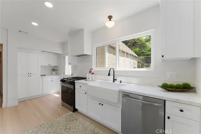 a kitchen with a sink stove and cabinets
