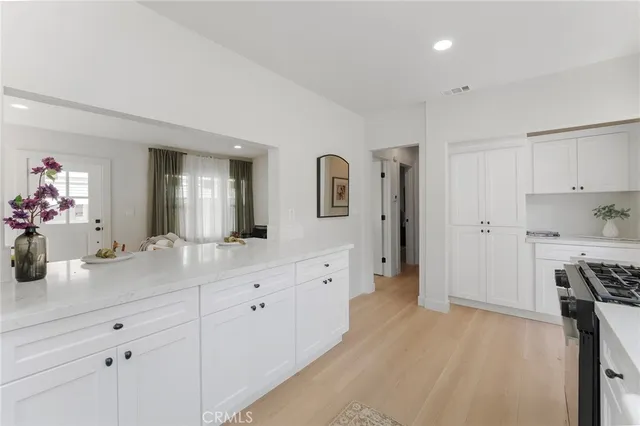 a spacious bathroom with a granite countertop sink mirror and bathtub