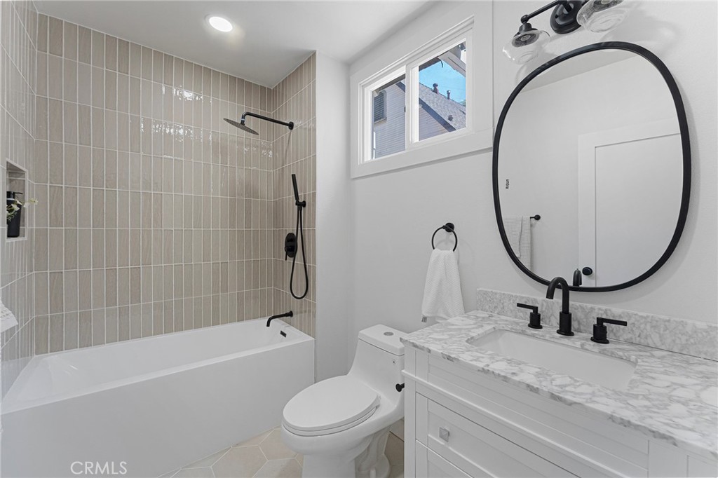 2628 Crestmoore Place Los Angeles, CA 90065 - Photo 10 of 14 a bathroom with a granite countertop toilet a sink and a mirror