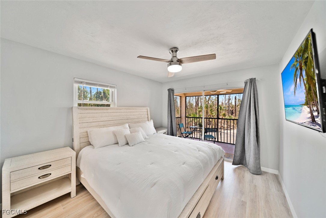 16881 Davis Road, Unit 721 Fort Myers, FL 33908 - Photo 15 of 23 a bedroom with a large bed and a chandelier