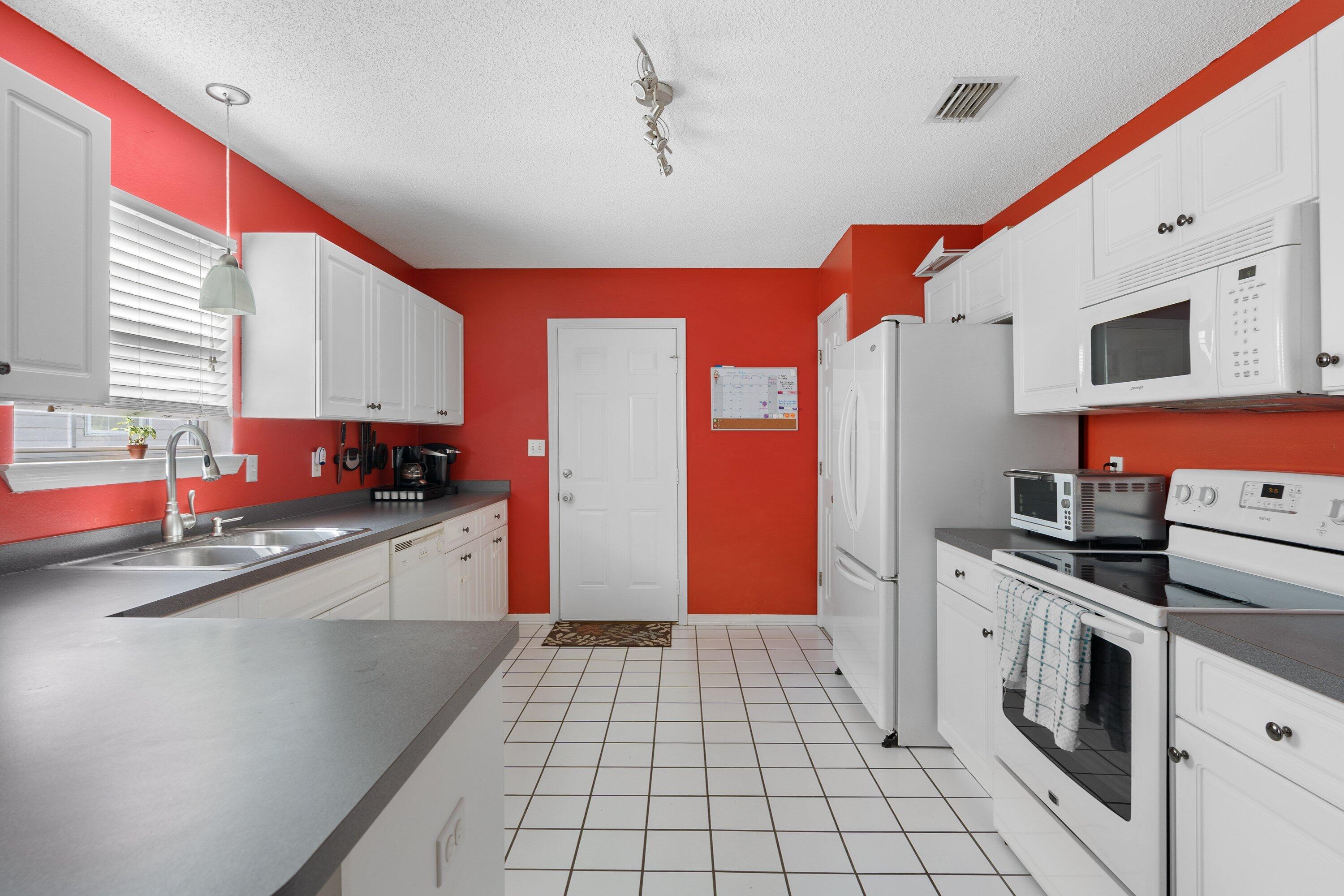 1761 Old Ranch Road Fort Walton Beach, FL 32547 - Photo 12 of 33 a kitchen with a stove a sink and a refrigerator