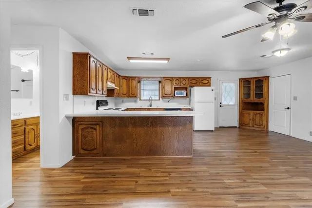 a view of kitchen with granite countertop cabinets and wooden floor