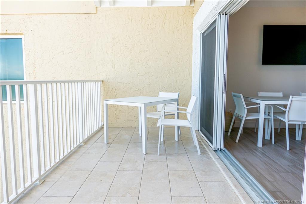 245 Northeast MacArthur Boulevard, Unit 5 Stuart, FL 34996 - Photo 11 of 38 a dining room with furniture and a floor to ceiling window