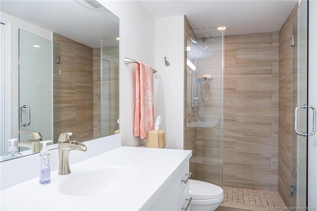 245 Northeast MacArthur Boulevard, Unit 5 Stuart, FL 34996 - Photo 20 of 38 a bathroom with a sink toilet and shower