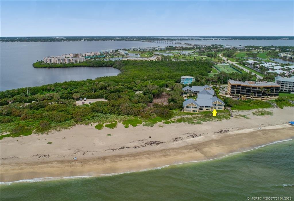 245 Northeast MacArthur Boulevard, Unit 5 Stuart, FL 34996 - Photo 2 of 38 an aerial view of a house with a garden and lake view