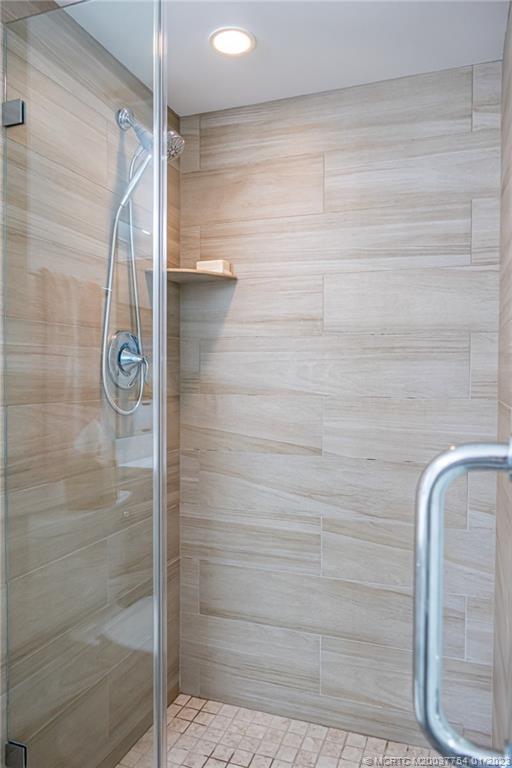 245 Northeast MacArthur Boulevard, Unit 5 Stuart, FL 34996 - Photo 21 of 38 a bathroom with a shower