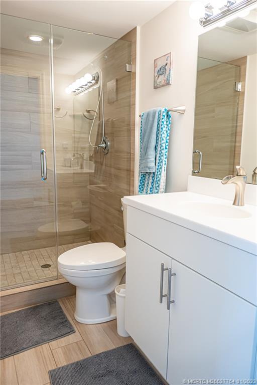 245 Northeast MacArthur Boulevard, Unit 5 Stuart, FL 34996 - Photo 22 of 38 a bathroom with a sink toilet and shower