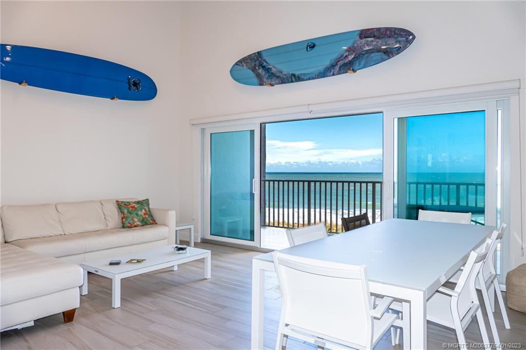 245 Northeast MacArthur Boulevard, Unit 5 Stuart, FL 34996 - Photo 26 of 38 a bedroom with a bed and a table