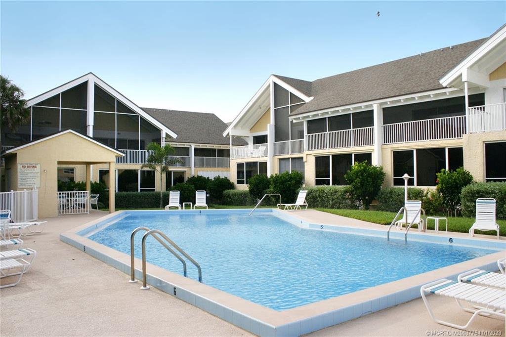 245 Northeast MacArthur Boulevard, Unit 5 Stuart, FL 34996 - Photo 37 of 38 a view of house with yard and sitting area