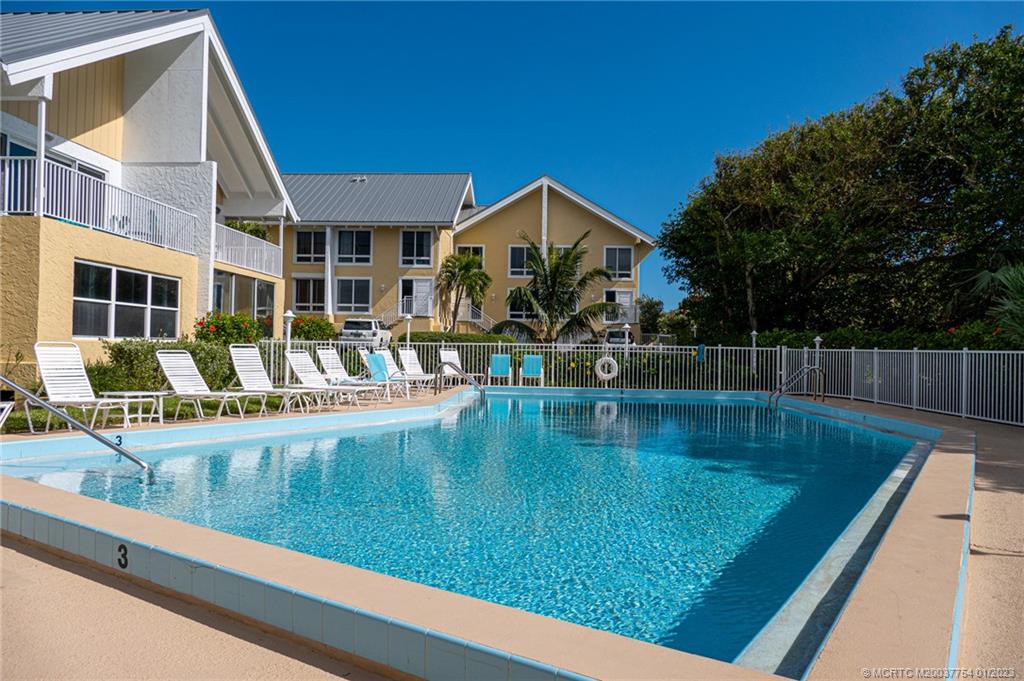 245 Northeast MacArthur Boulevard, Unit 5 Stuart, FL 34996 - Photo 38 of 38 a view of pool with outdoor seating