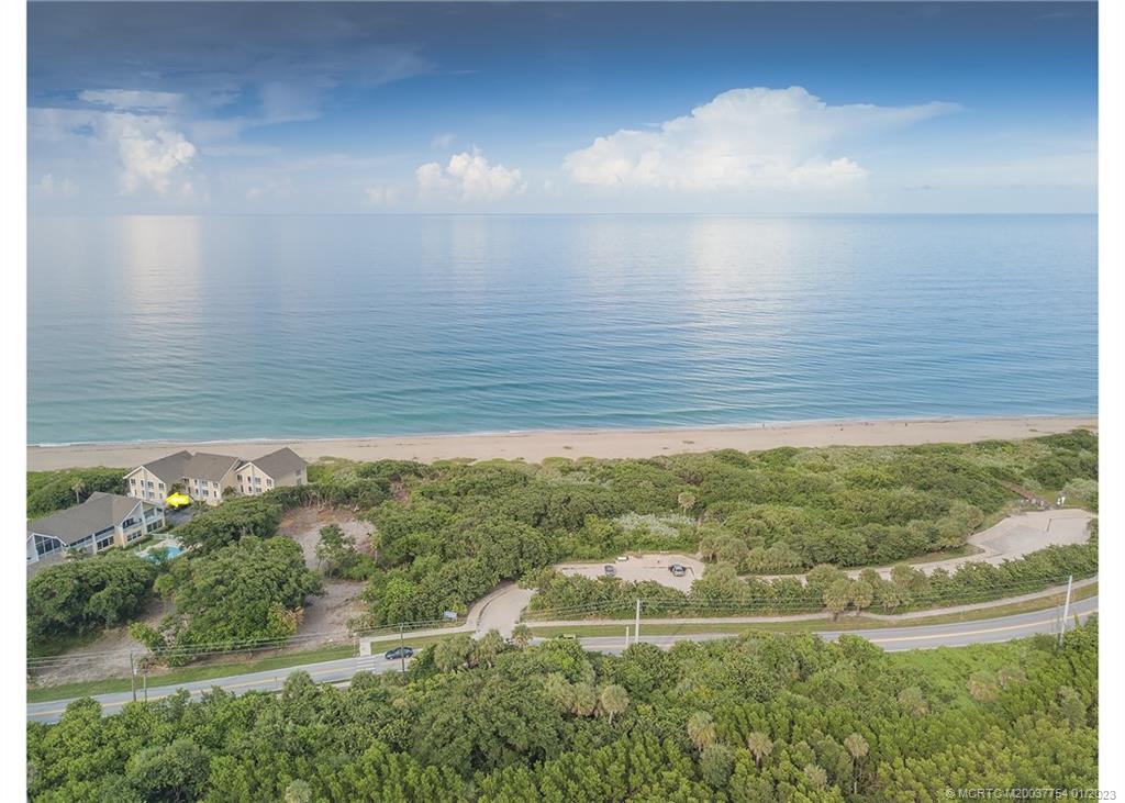 245 Northeast MacArthur Boulevard, Unit 5 Stuart, FL 34996 - Photo 4 of 38 a view of a lake with a yard