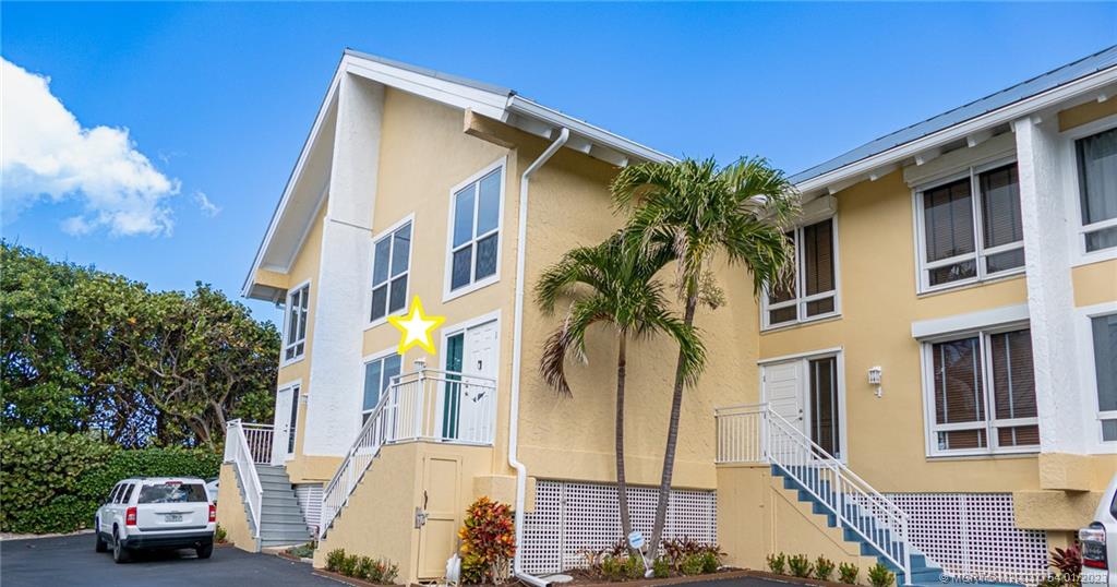 245 Northeast MacArthur Boulevard, Unit 5 Stuart, FL 34996 - Photo 7 of 38 a view of a street with cars