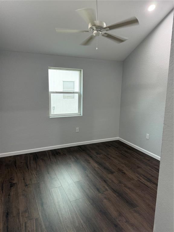 103 South Roger Avenue Arcadia, FL 34266 - Photo 21 of 22 an empty room with wooden floor fan and windows