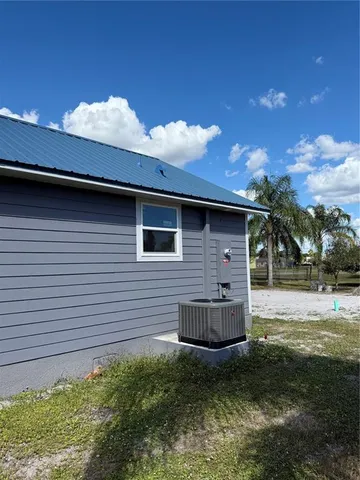 a backyard of a house with table and chairs