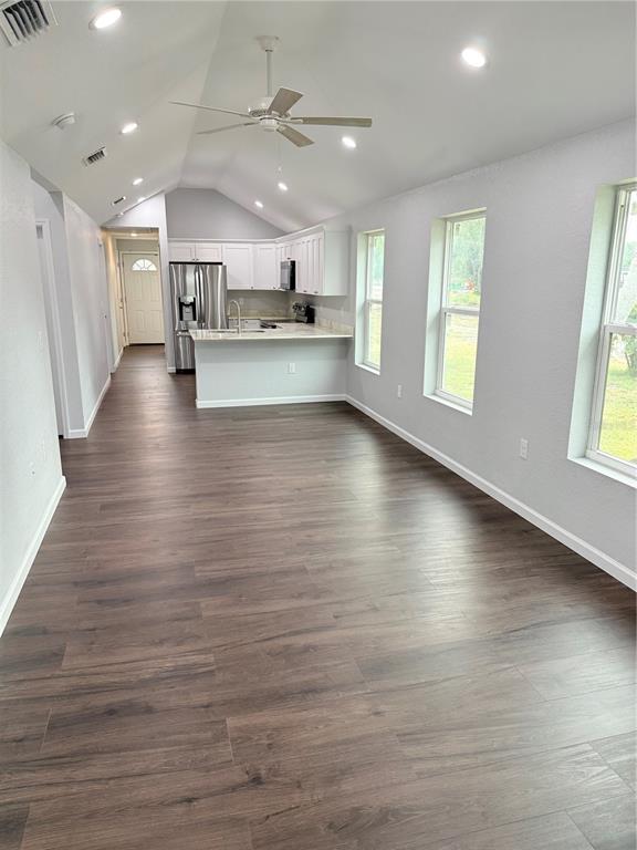 103 South Roger Avenue Arcadia, FL 34266 - Photo 8 of 22 an empty room with wooden floor and windows