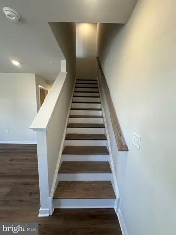 a view of kitchen with refrigerator microwave and wooden floor