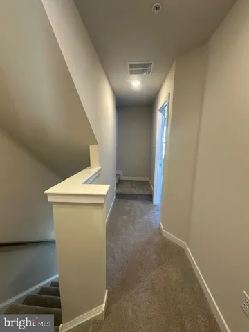 a view of a room with wooden floor and a bathroom