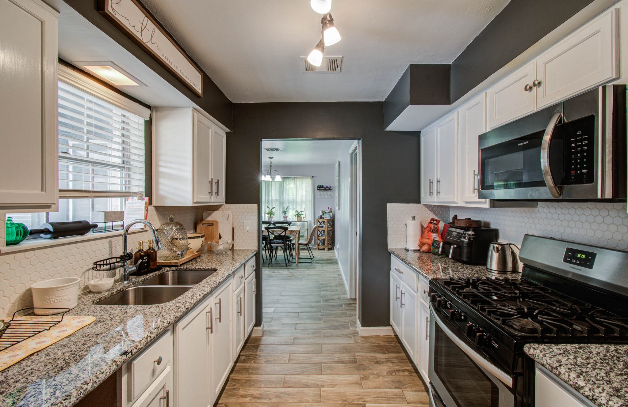 1327 Fallbrook Drive Houston, TX 77038 - Photo 11 of 34 Kitchen with stainless steel appliances, granite countertops, tile backsplash.