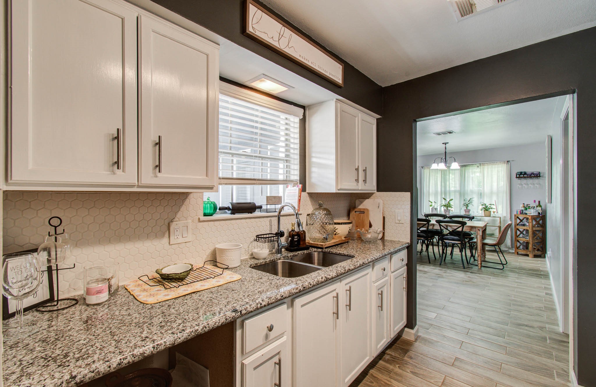 1327 Fallbrook Drive Houston, TX 77038 - Photo 14 of 34 Kitchen with stainless steel appliances, granite countertops, tile backsplash.