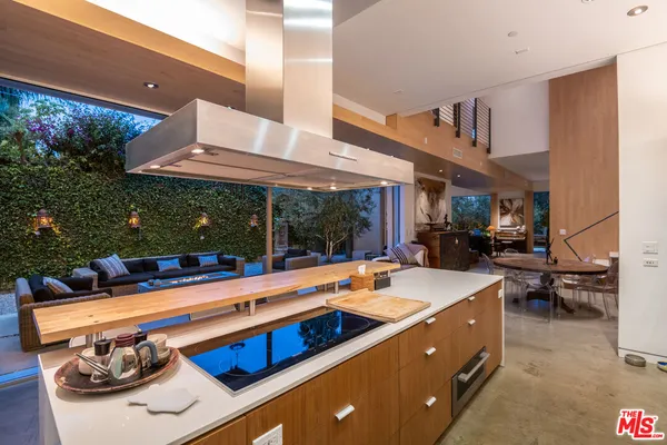 a view of a patio with table and chairs and potted plants