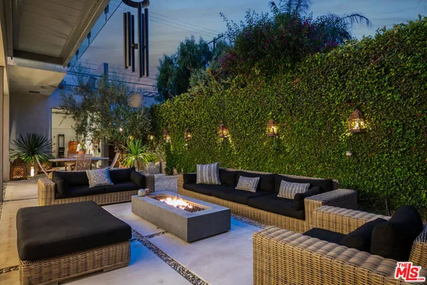 a view of a patio with couches and a potted plant on a table and table