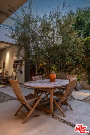 a view of a backyard with a table and chairs