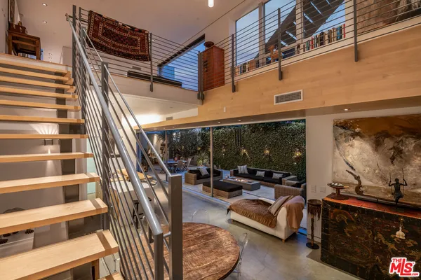 a view of living room furniture and a floor to ceiling window