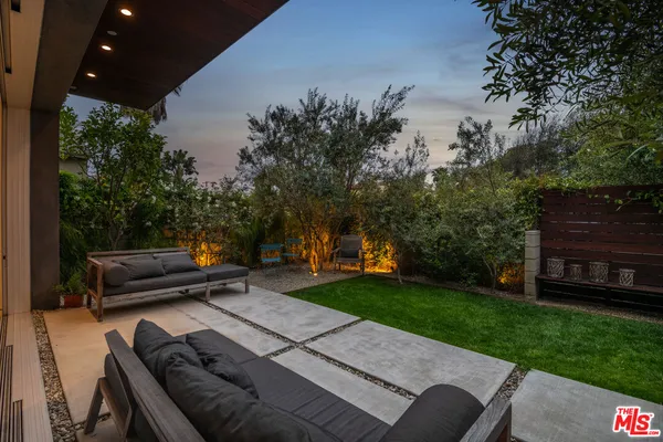 a view of a backyard with sitting area