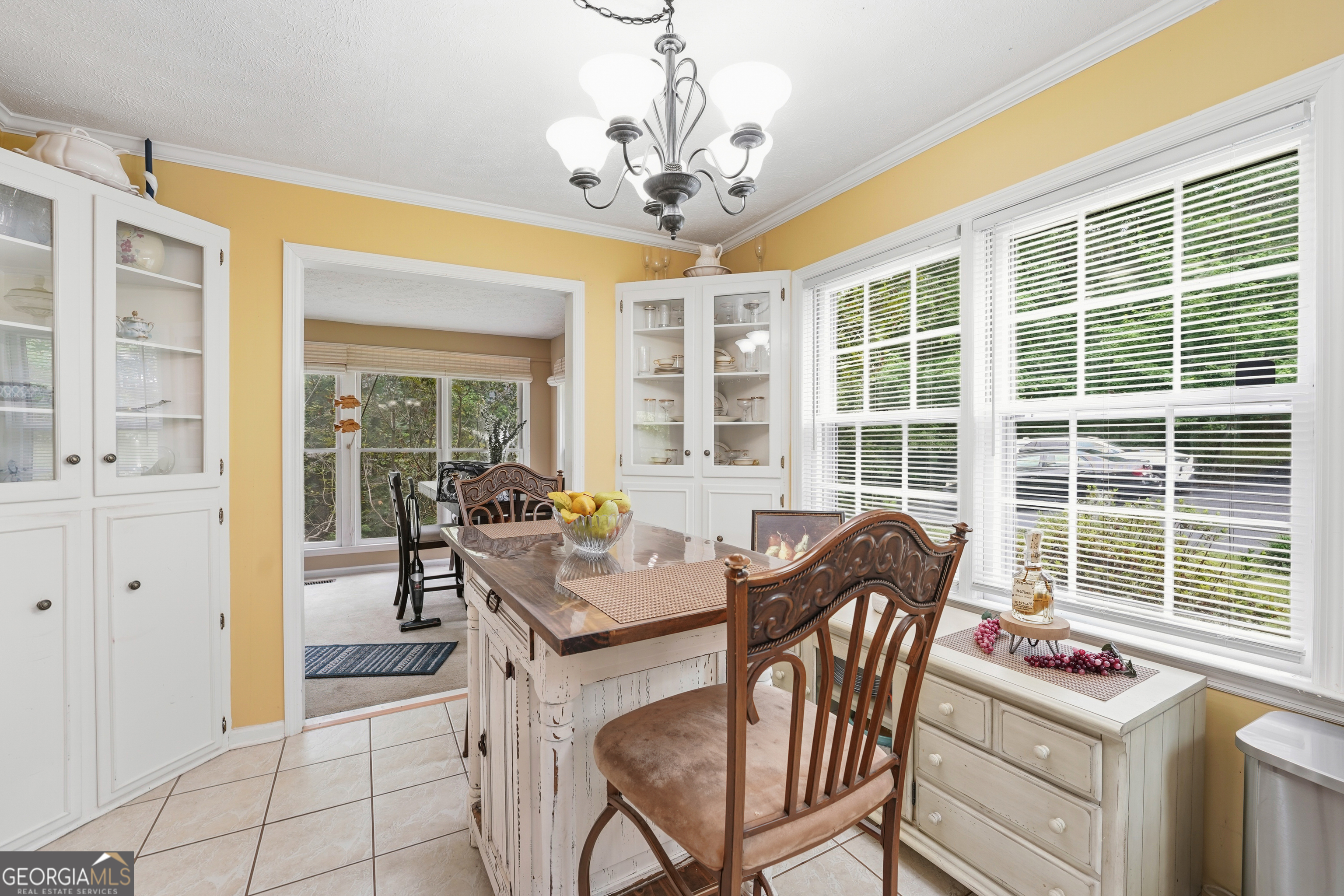 142 Tanglewood Road Southwest Eatonton, GA 31024 - Photo 11 of 50 a dining room with wooden floor a chandelier a glass table and chairs